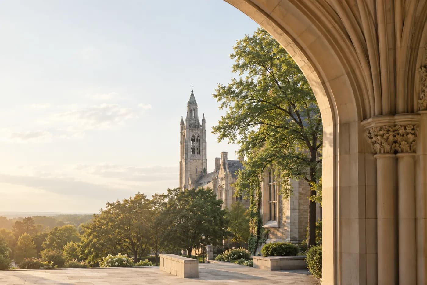A quiet university courtyard framed by a limestone arch